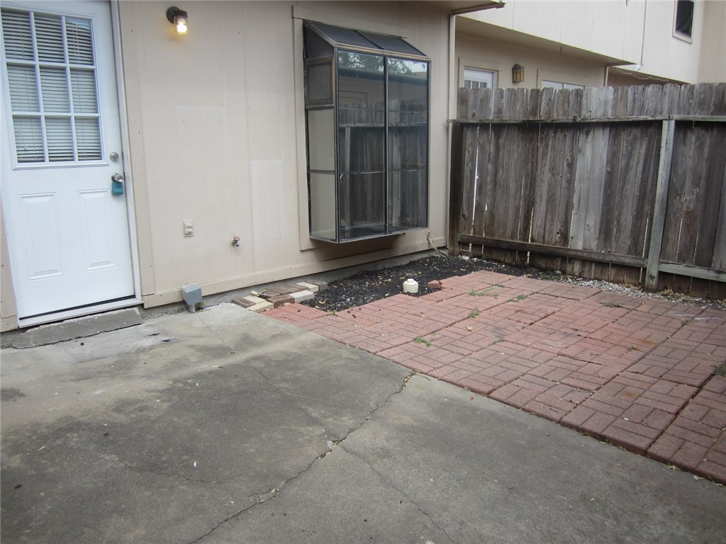 6702 Everhart Road, Unit H103 Corpus Christi, TX 78413 - Photo 13 of 14 a view of wooden door and brick wall