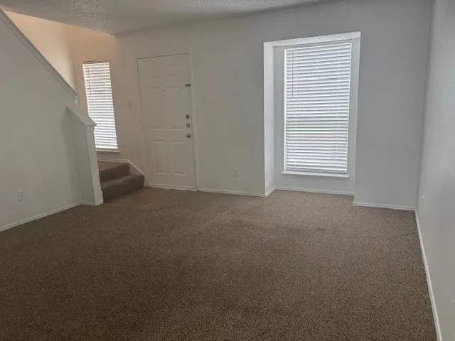 a view of empty room with windows