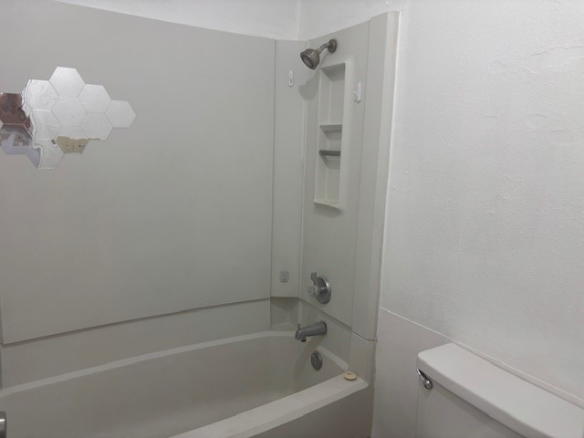 6702 Everhart Road, Unit H103 Corpus Christi, TX 78413 - Photo 10 of 14 a bath room with a shower curtain and a sink