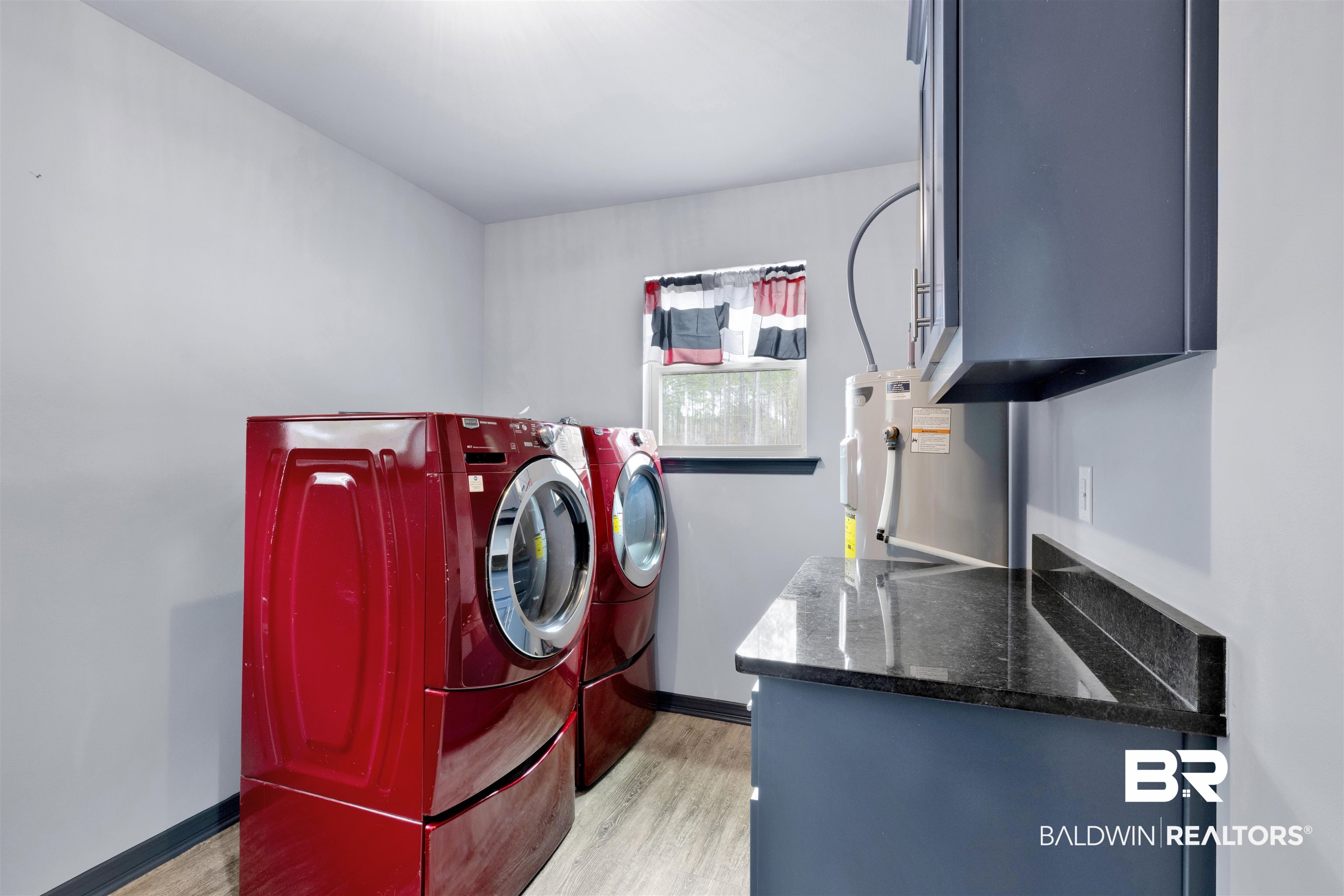 36397 Alexandria Trail Stapleton, AL 36578 - Photo 46 of 65 Laundry room featuring separate washer and dryer, light wood-type flooring, and water heater