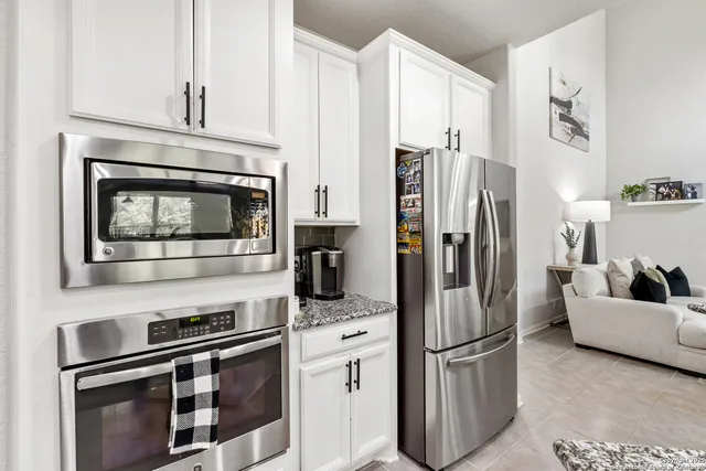 a kitchen with stainless steel appliances a refrigerator stove and microwave
