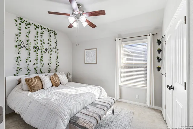 a bedroom with a large bed and a window