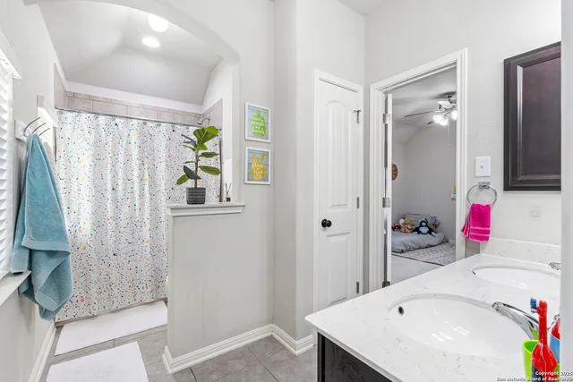 a bathroom with a sink vanity tub and shower