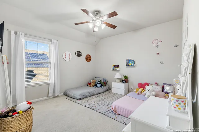a bedroom with furniture and a chandelier