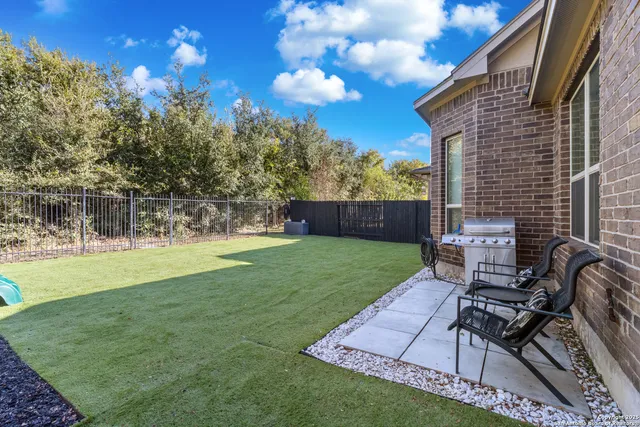a view of a backyard with sitting area