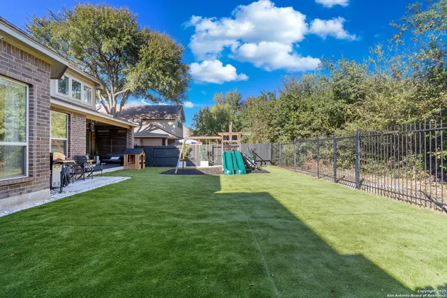 a view of yard with swimming pool and sitting area