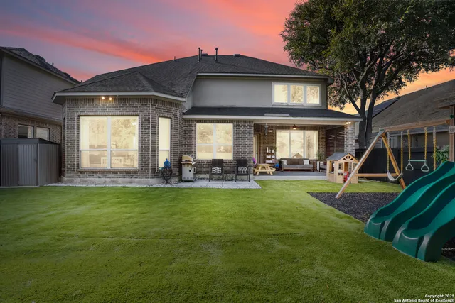 a view of a house with backyard and a slide