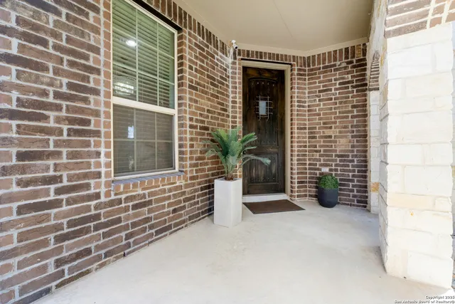 a view of house with potted plant in front of door