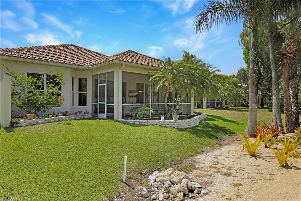 349 Harvard Lane Naples, FL 34104 - Photo 21 of 29 a front view of a house with garden