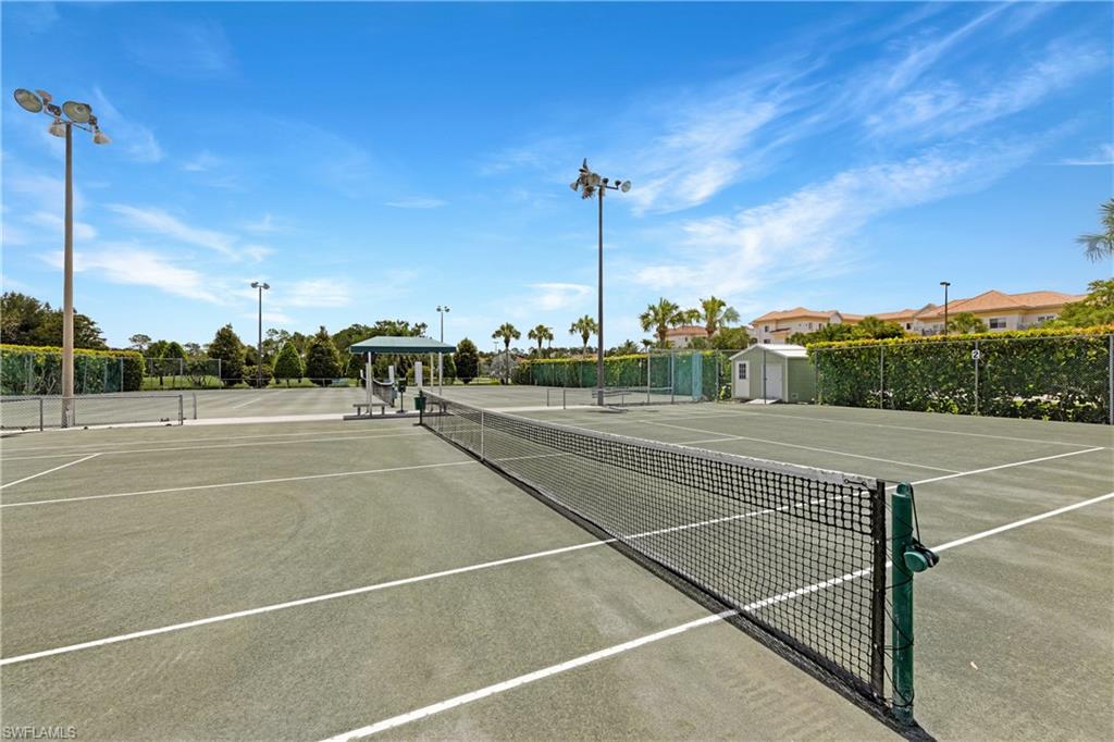 349 Harvard Lane Naples, FL 34104 - Photo 25 of 29 a view of a tennis court with lamp on the road