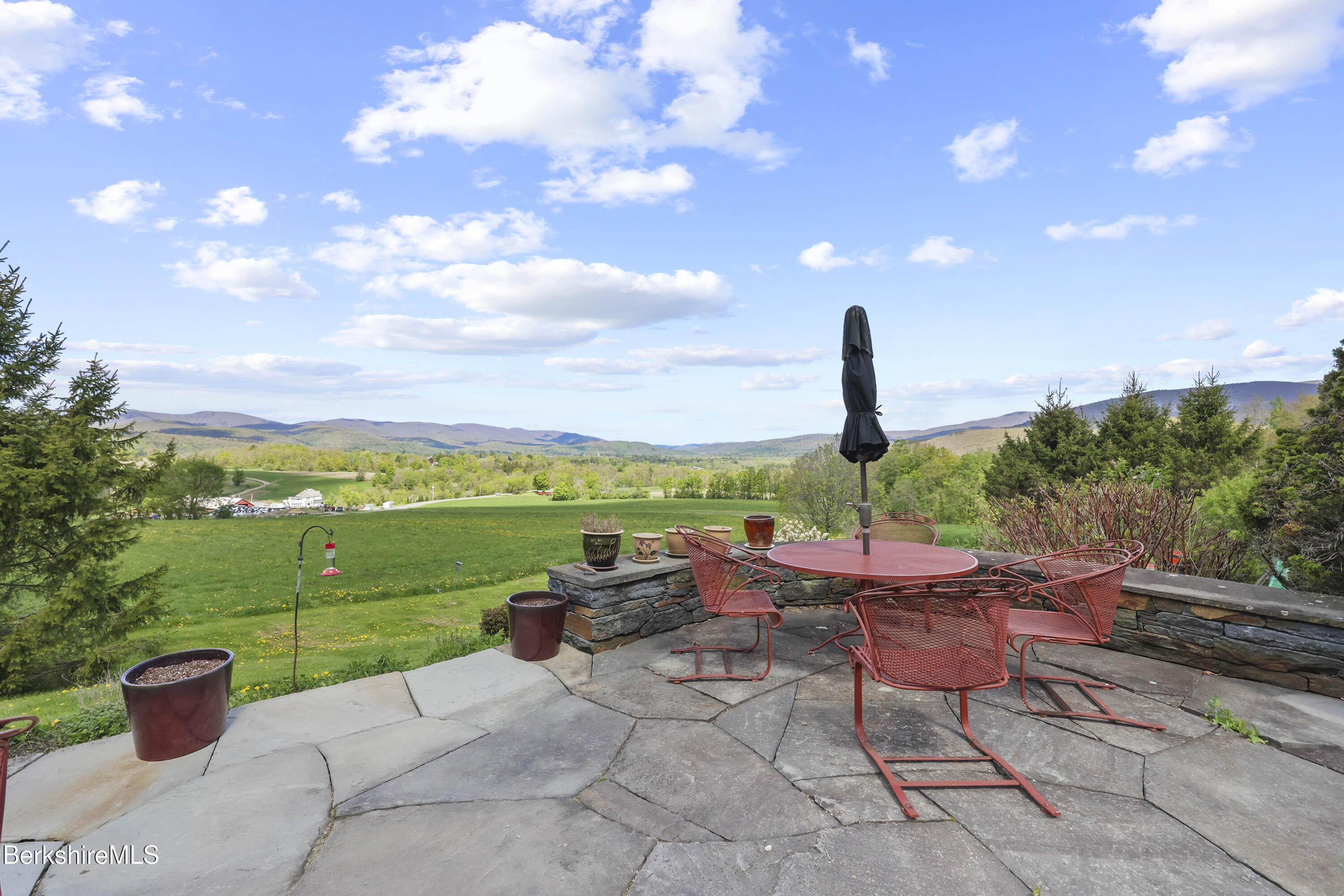 821 Pattison Road North Adams, MA 01247 - Photo 51 of 68 a view of a patio with a dining table and chairs with a fire pit