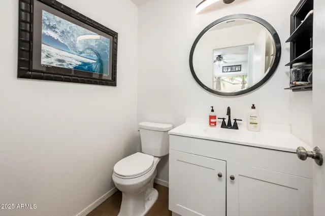 a bathroom with a toilet a sink and a mirror