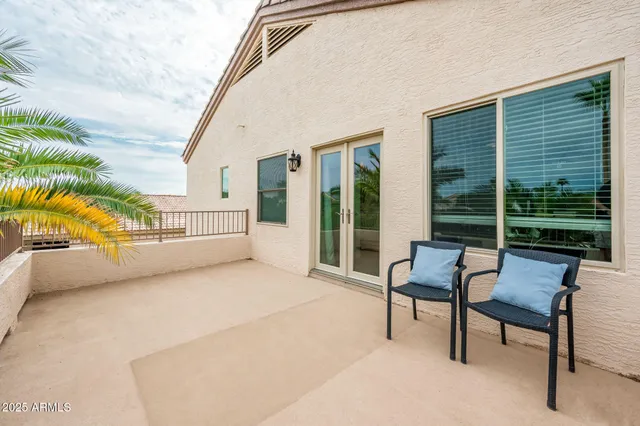 a view of a house with backyard and sitting area