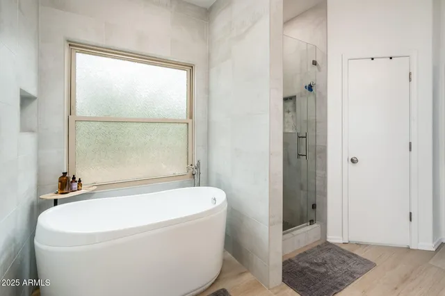 a white bath tub sitting next to a window