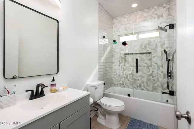 a utility room with dryer washer and a view of living room