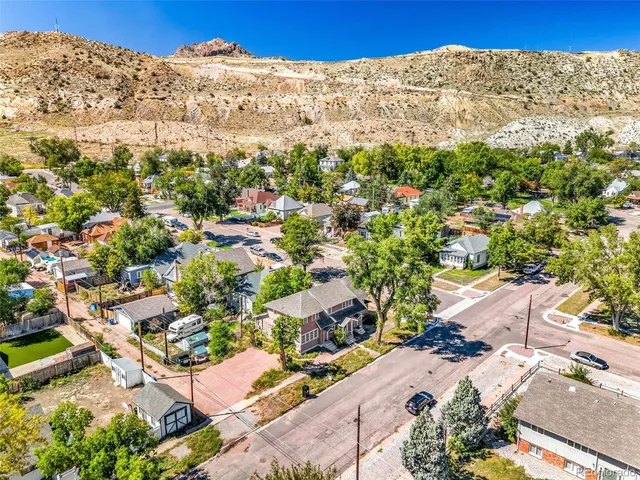 a view of a building in the distance covered with wooden fence