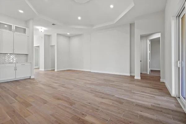 a view of a kitchen with wooden floor