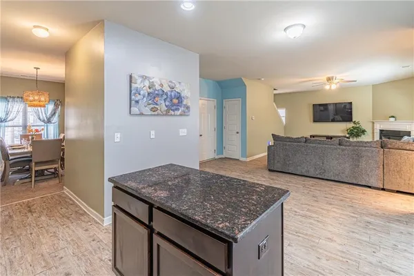 a living room with granite countertop furniture and kitchen view