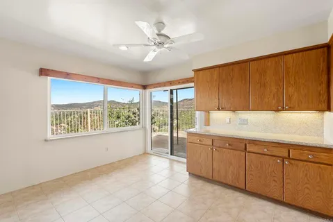 a large white kitchen with a large window