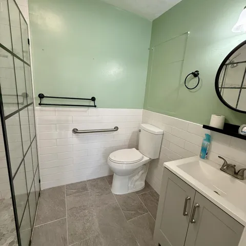 a bathroom with a toilet a sink and a mirror