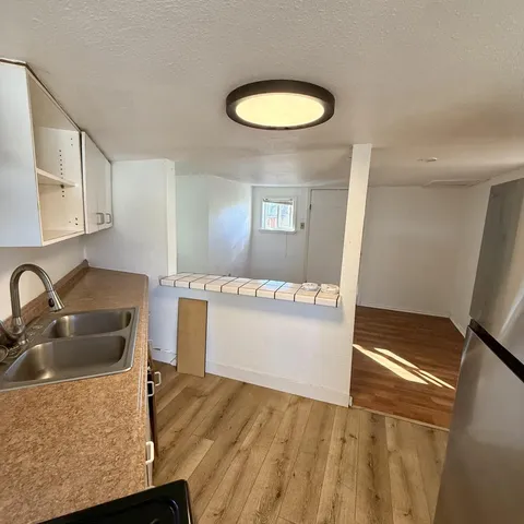 a kitchen with sink and refrigerator