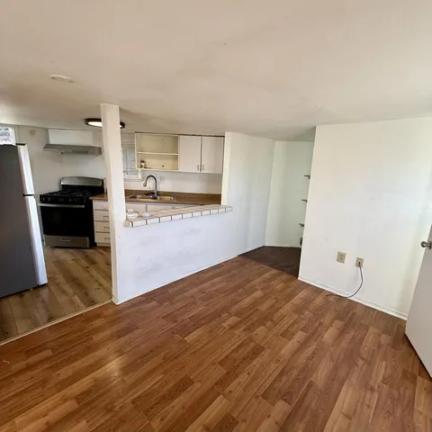 a view of a kitchen with wooden floor