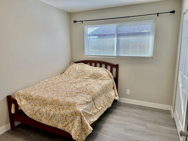 a bed sitting in a bedroom next to a window