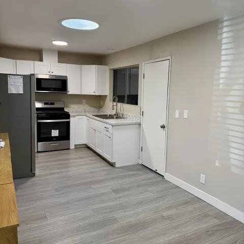 a kitchen with stainless steel appliances a refrigerator and a stove top oven