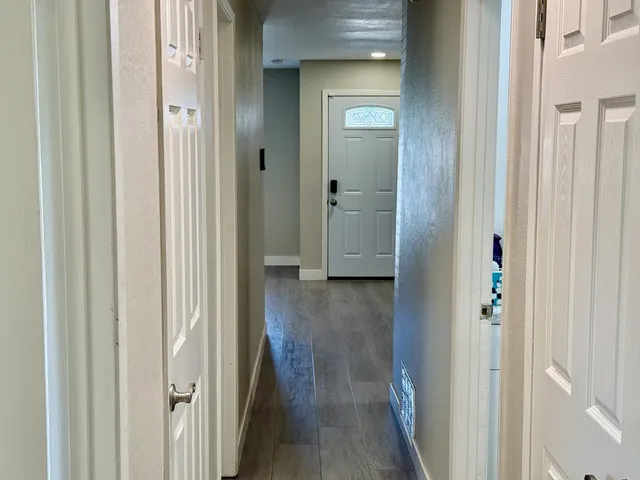 a view of a hallway with a wooden door