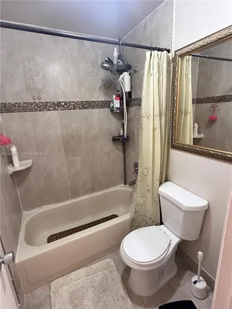 a living room with furniture and large window