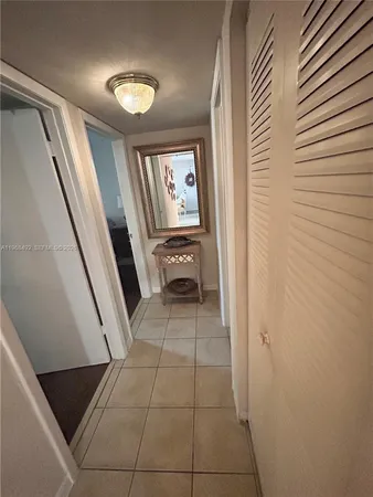 a bedroom with a bed and a mirror on dresser