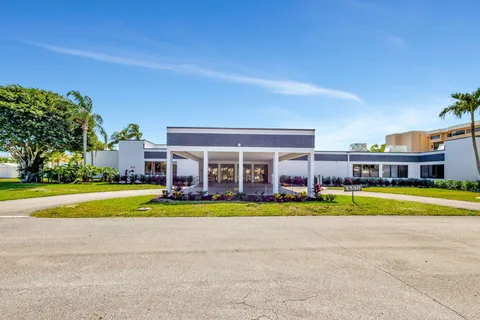 a view of a big room with a big yard and large trees