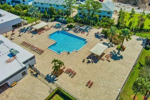 an aerial view of a house with a yard and lake view
