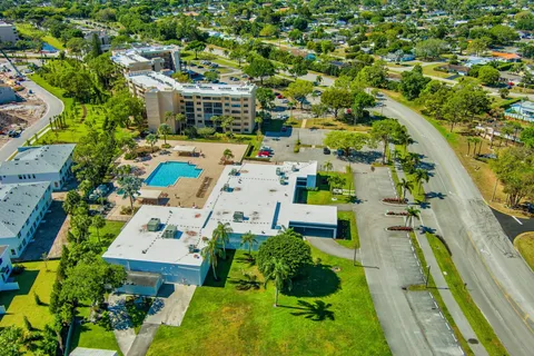 an aerial view of multiple houses with yard