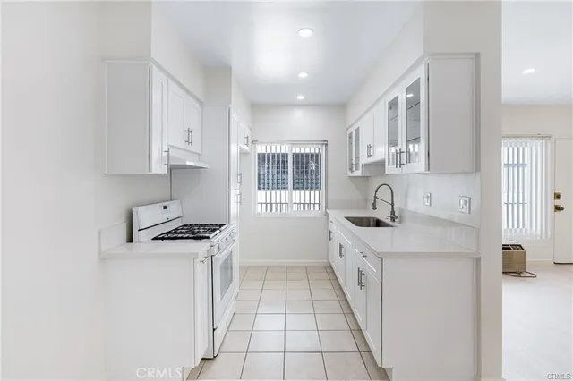 a kitchen with stainless steel appliances granite countertop a sink and a stove