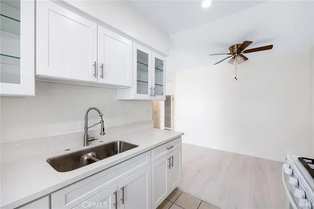 a kitchen with stainless steel appliances a sink a refrigerator and cabinets