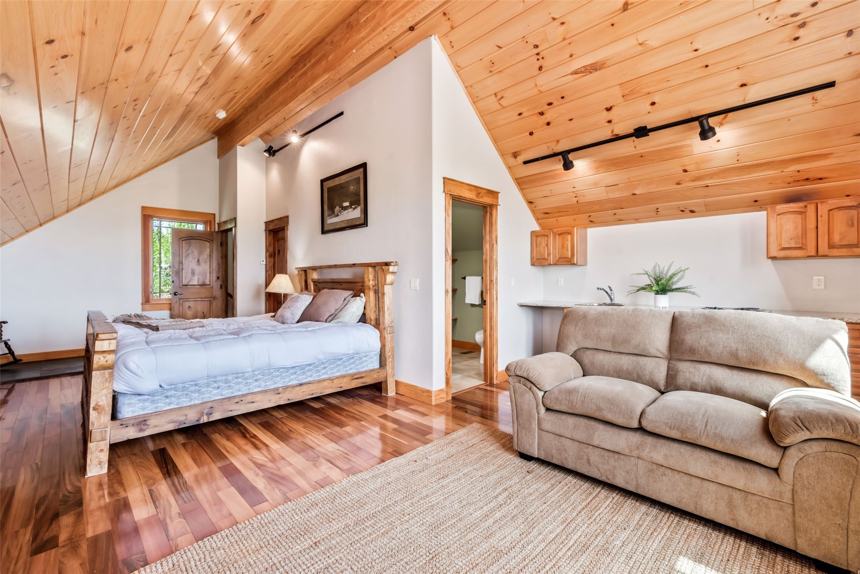 51193 Smith Creek Road Steamboat Springs, CO 80487 - Photo 24 of 48 a bedroom with a large bed and a couch