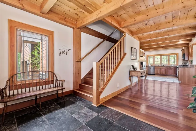 a bedroom with a bed a flat screen tv and a chandelier