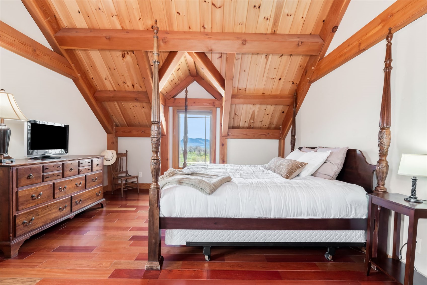 51193 Smith Creek Road Steamboat Springs, CO 80487 - Photo 28 of 48 a bedroom with a bed a flat screen tv and a dresser