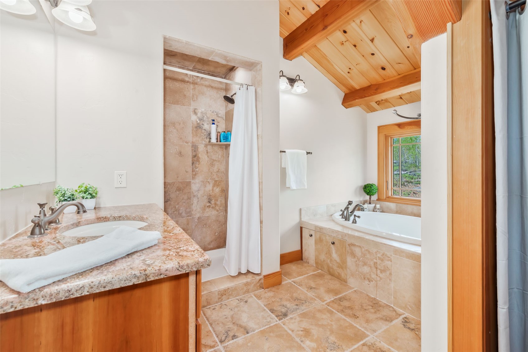 51193 Smith Creek Road Steamboat Springs, CO 80487 - Photo 30 of 48 a bathroom with a granite countertop sink and a mirror