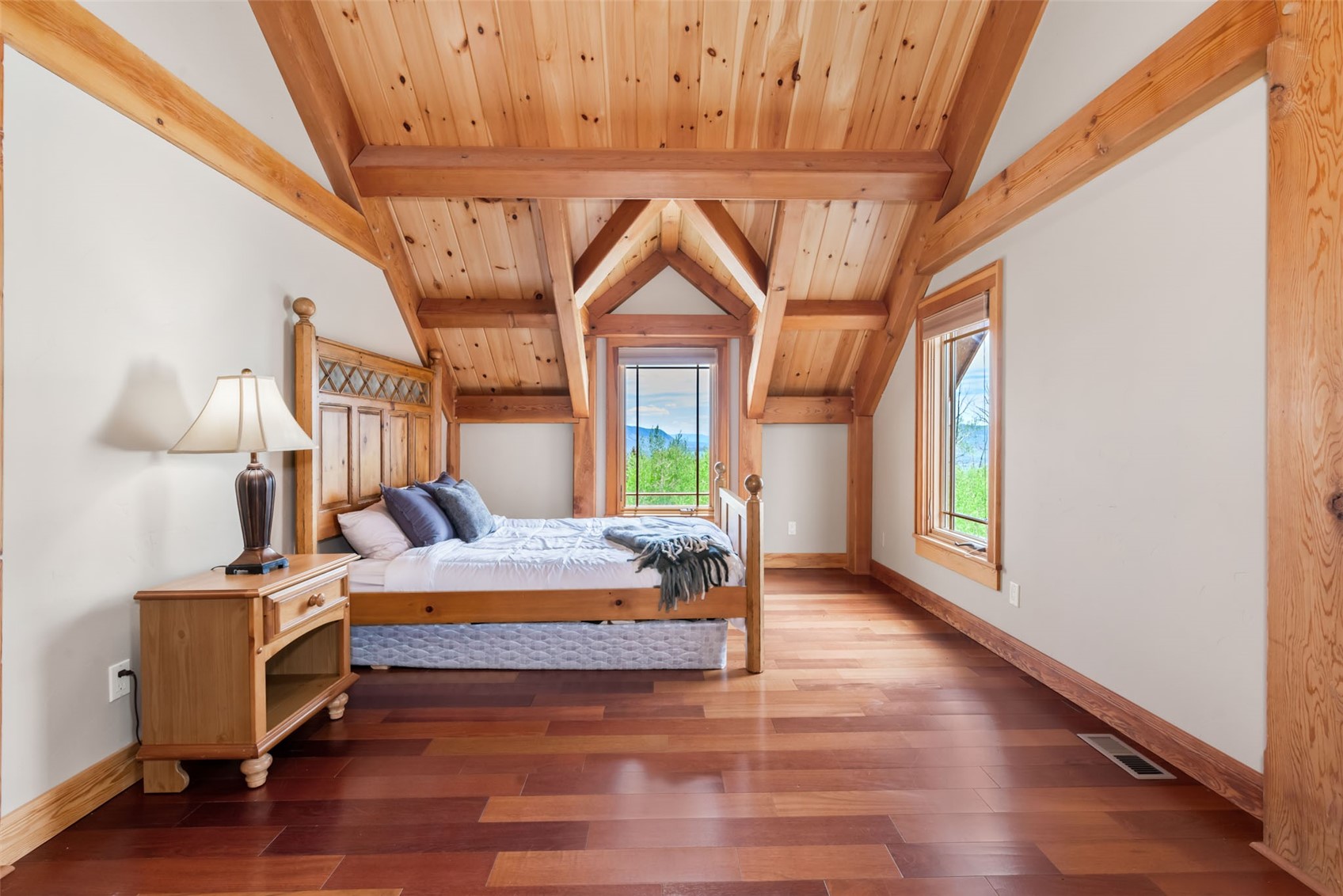 51193 Smith Creek Road Steamboat Springs, CO 80487 - Photo 33 of 48 a bedroom with a bed and wooden floor