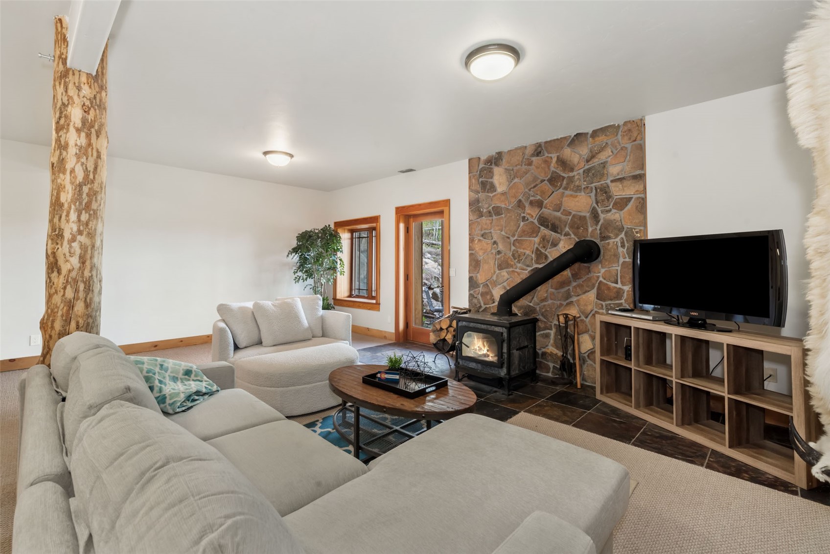 51193 Smith Creek Road Steamboat Springs, CO 80487 - Photo 37 of 48 a living room with furniture and a flat screen tv