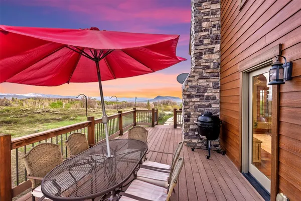 a view of a balcony with furniture and umbrella