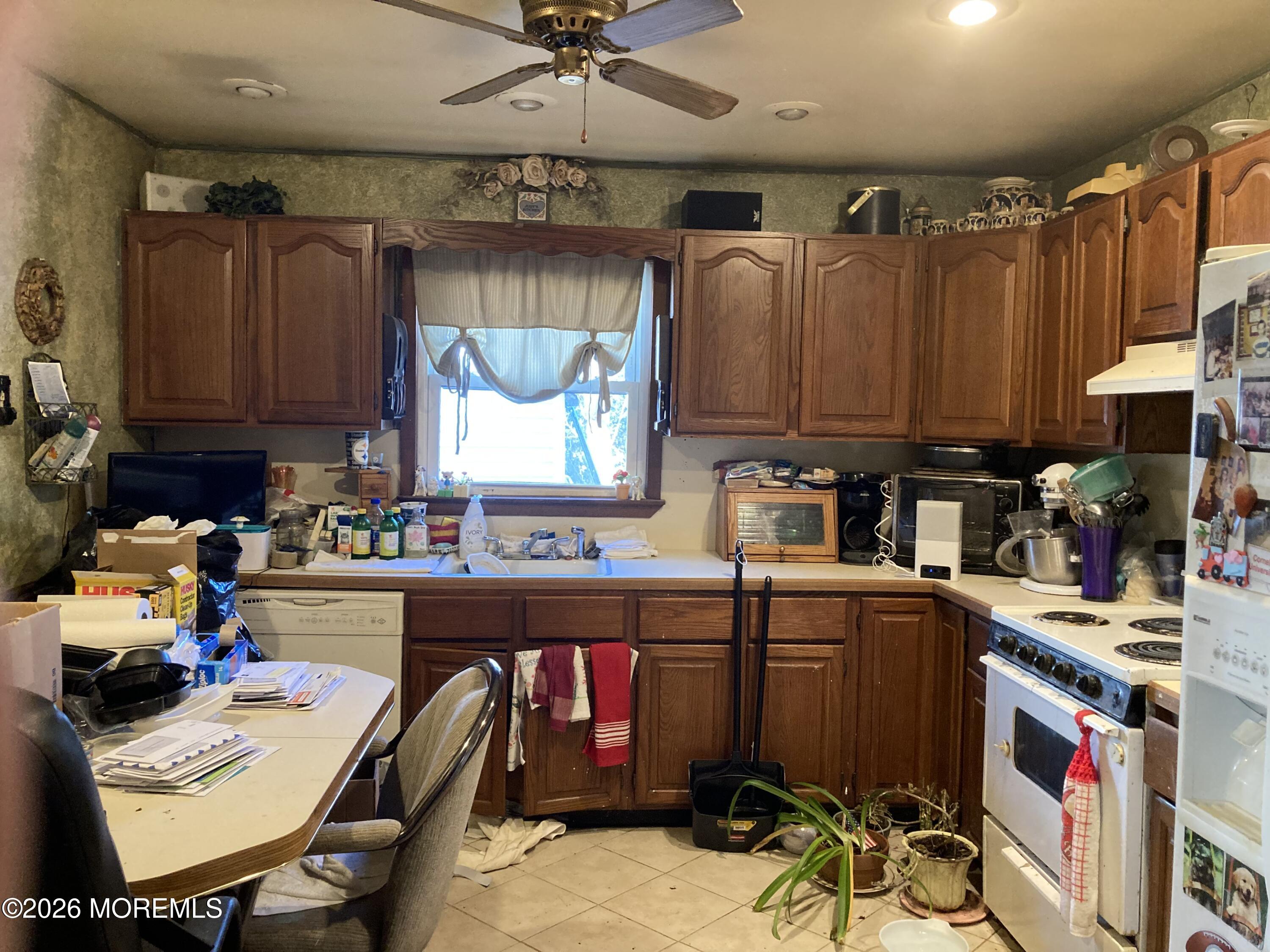 152 Chapel Hill Road Middletown, NJ 07701 - Photo 9 of 18 a kitchen with a refrigerator and a stove top oven