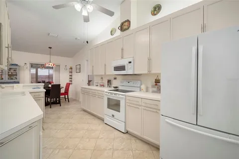 a kitchen with lot of cabinets a sink and appliances