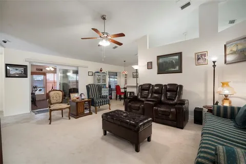 a view of a livingroom with workspace and a window