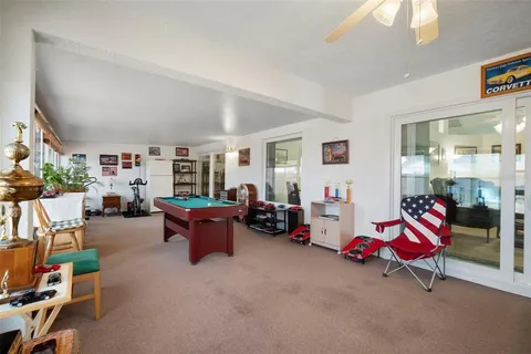 a living room with furniture and a floor to ceiling window