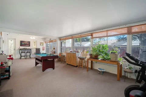a backyard of a house with barbeque oven table and chairs