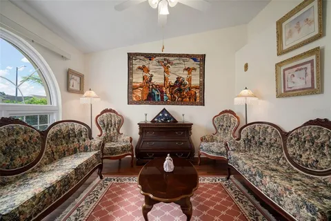 a living room with furniture a rug and a window
