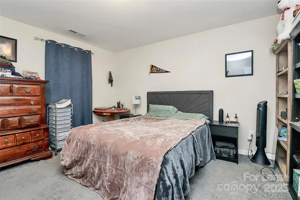 a bedroom with a bed and a tv